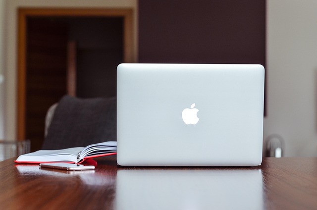 Professional headshot of female curriculum designer at desk with educational materials and computer